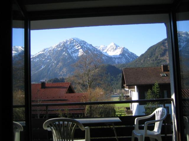 a view of a snowy mountain from a window at Ferienwohnung Halder, Ihr Bett im Allgäu in Bad Hindelang