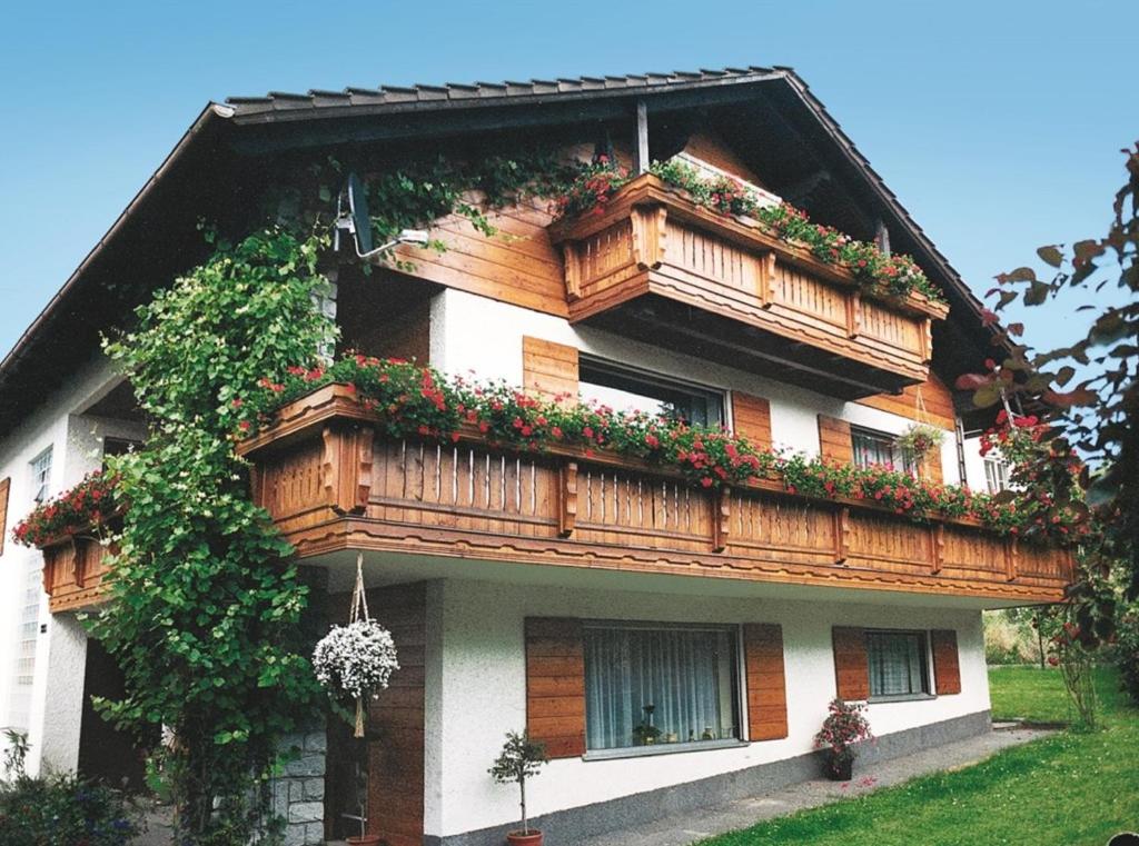 a house with a balcony with flowers on it at Fischer Willi in Bad Koetzting