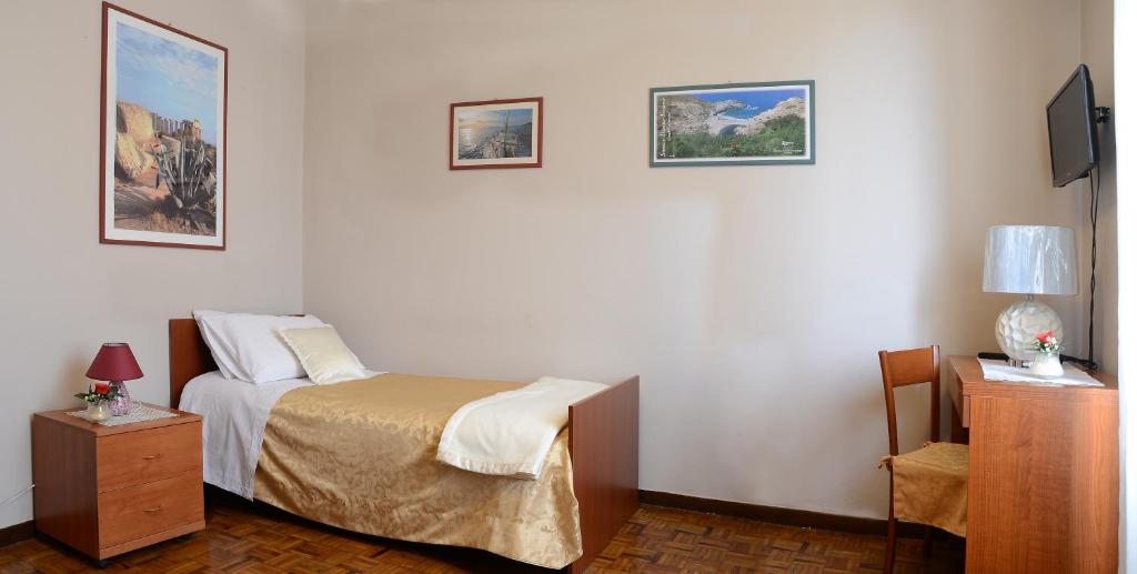 Postel nebo postele na pokoji v ubytování Hotel La Fenice