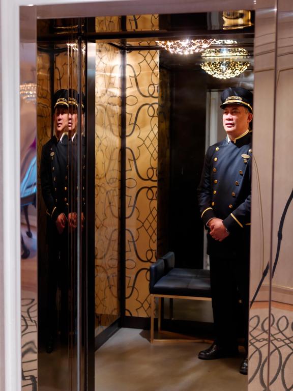 two men in uniforms are standing in a room at Hotel Continental in Oslo