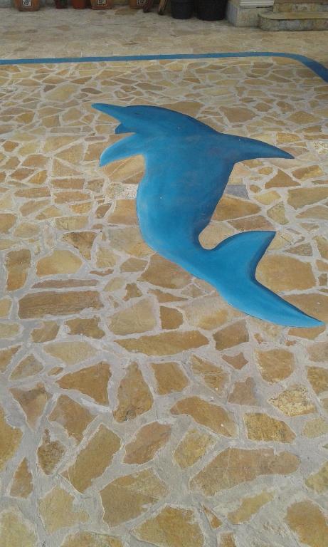 a statue of a blue bird on a stone floor at Buljarica Bay Apartments in Petrovac na Moru
