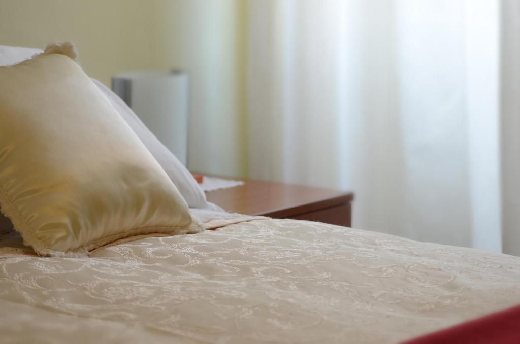 Postel nebo postele na pokoji v ubytování Hotel La Fenice