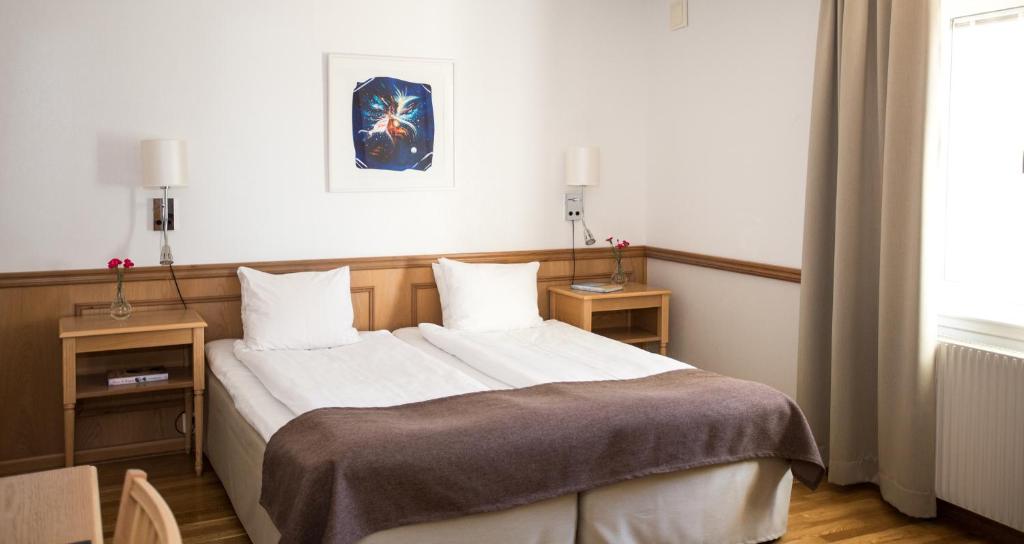 Postel nebo postele na pokoji v ubytování Hotel Skansen