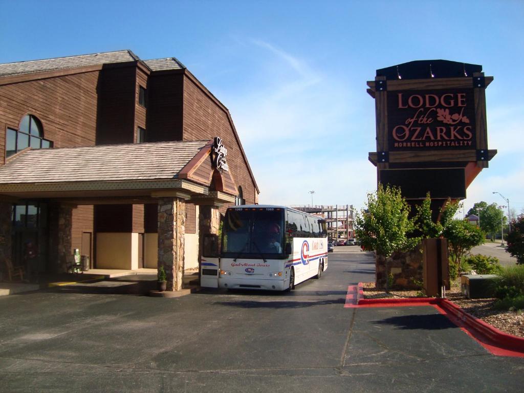 a bus parked in a parking lot next to a building at Lodge of the Ozarks in Branson