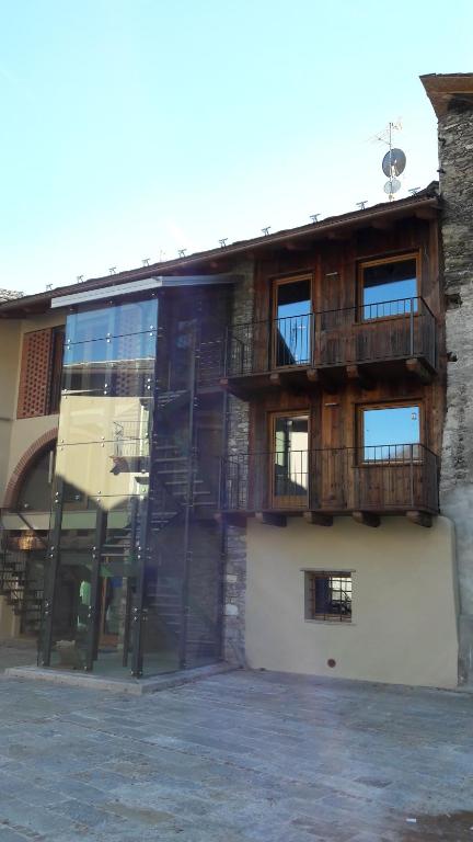 a building with balconies on the side of it at Malherbes in Aosta