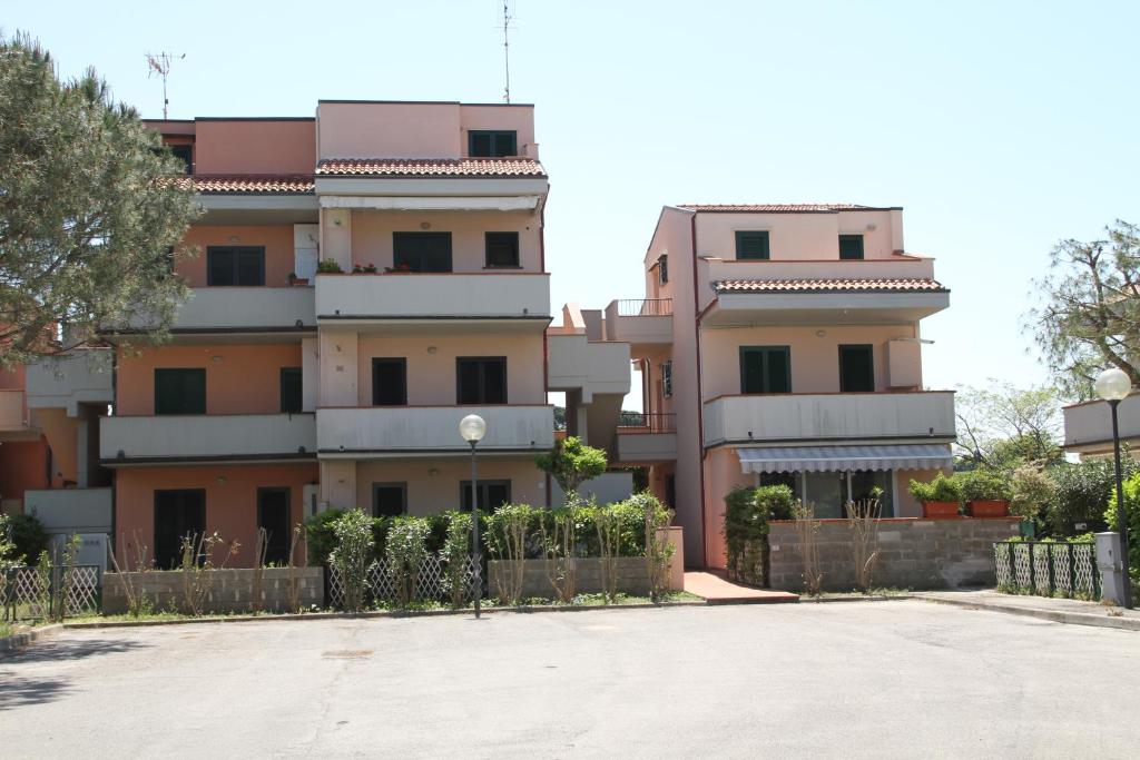 a building with a parking lot in front of it at Roberta Apartment in Marcelli
