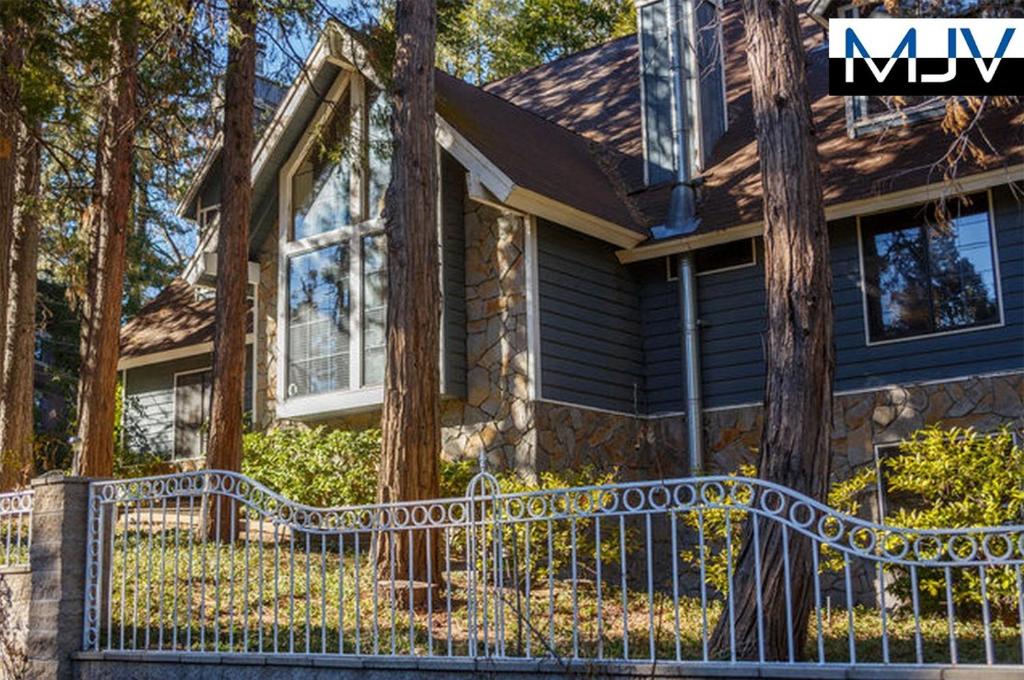 a house with a wrought iron fence in front of it at Chateau Bernina in Lake Arrowhead