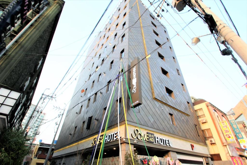 a tall building in the middle of a city at Some Hotel in Busan