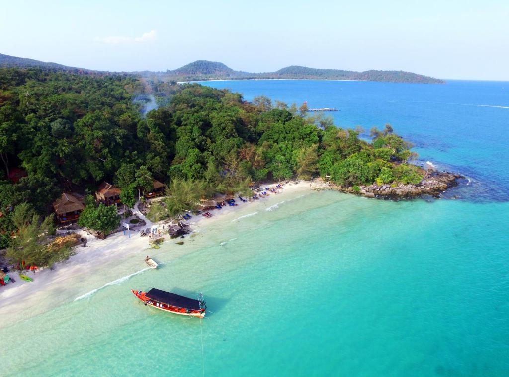 an aerial view of a beach with a boat in the water at White Beach Bungalows in Koh Rong Island