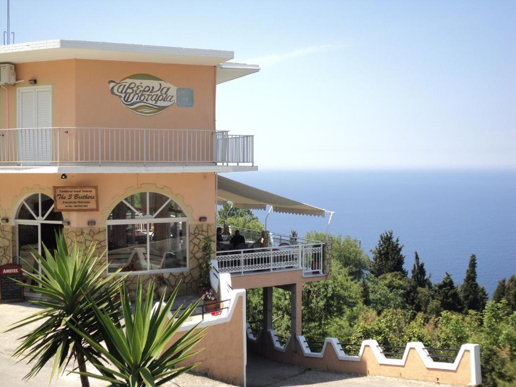 a restaurant with the ocean in the background at The 3 Brothers in Afionas