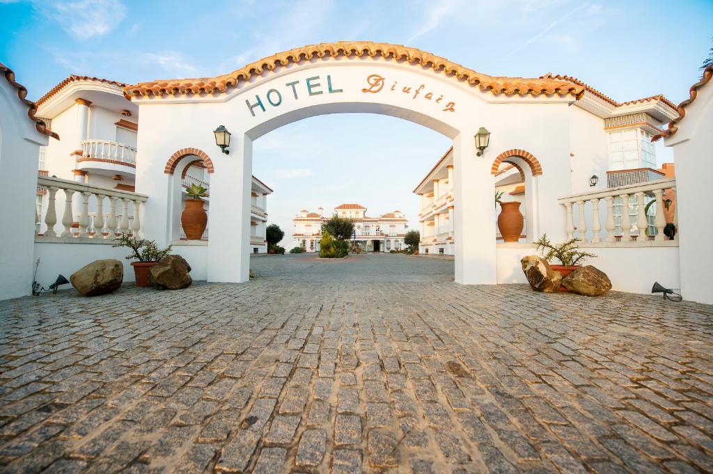 a hotel entrance with a hotel sign on it at Hotel Diufain in Conil de la Frontera