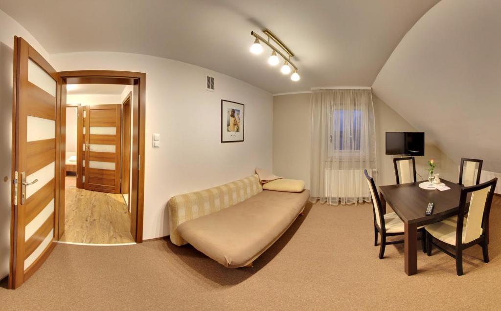a living room with a couch and a table at Apartamenty Pod Telegrafem in Kielce