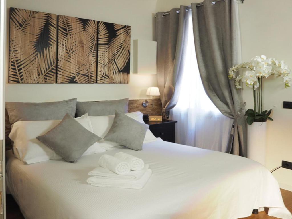 Un dormitorio con una cama blanca con toallas. en Residenza 54, en Florencia