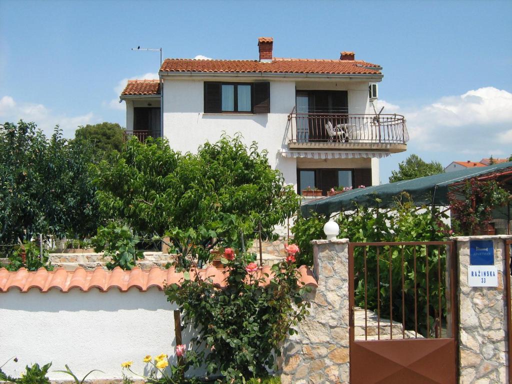 a villa with a view of a house at Apartmani Dragovic in Brodarica