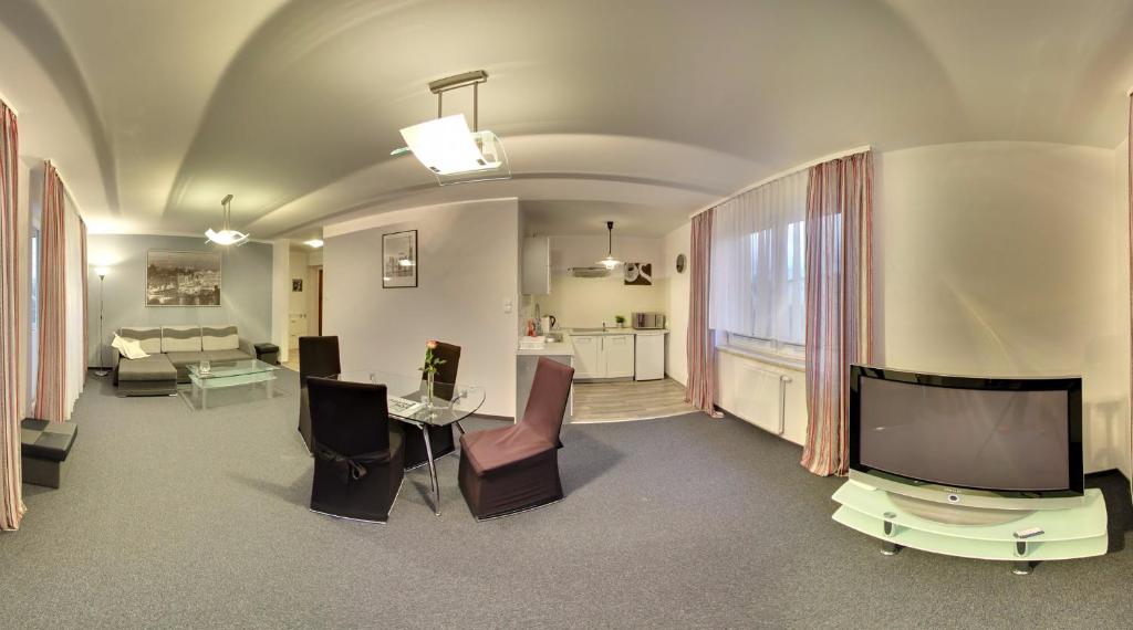 a living room with a tv and a couch and a table at Apartamenty Pod Telegrafem in Kielce