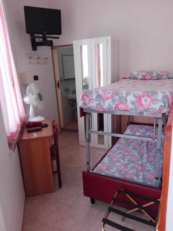 Postel nebo postele na pokoji v ubytování Hotel Parigi