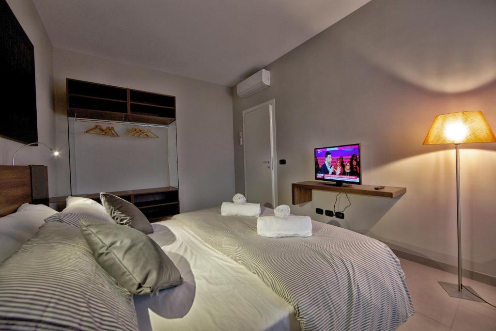 A bed or beds in a room at lepini suites affittacamere