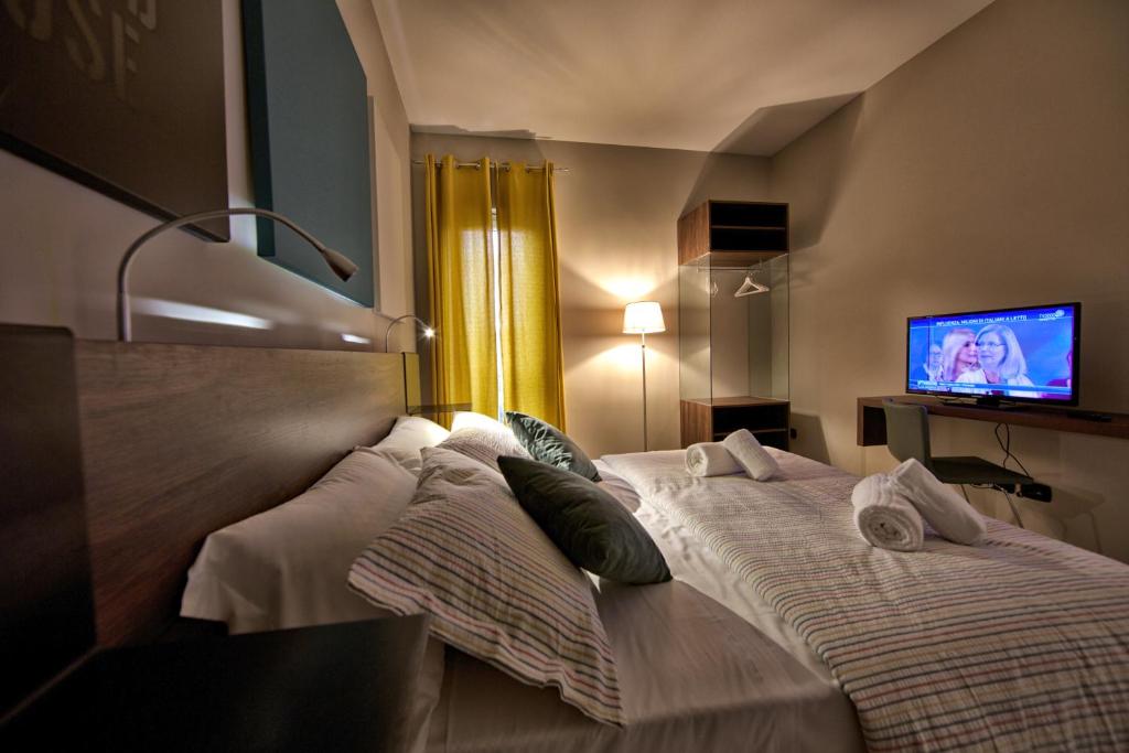 A bed or beds in a room at lepini suites affittacamere
