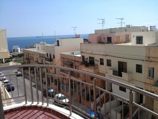 a view of a city from a balcony of a building at Maltarentapartments in Marsaskala