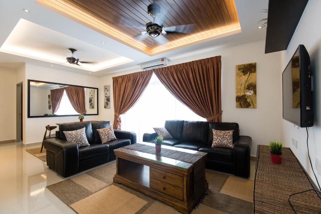 a living room with a couch and a table at Palm Armada Residence Free Parking and Netflix in Putrajaya