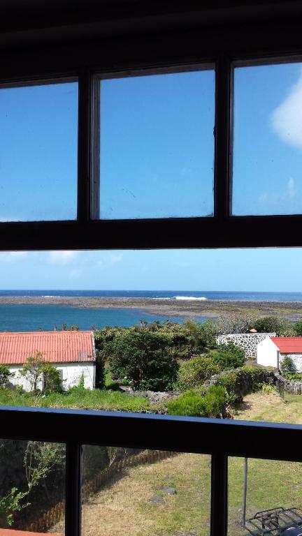 a view of the ocean from a window at Casa da Lagoa AL 416 in Fajã da Caldeira de Santo Cristo