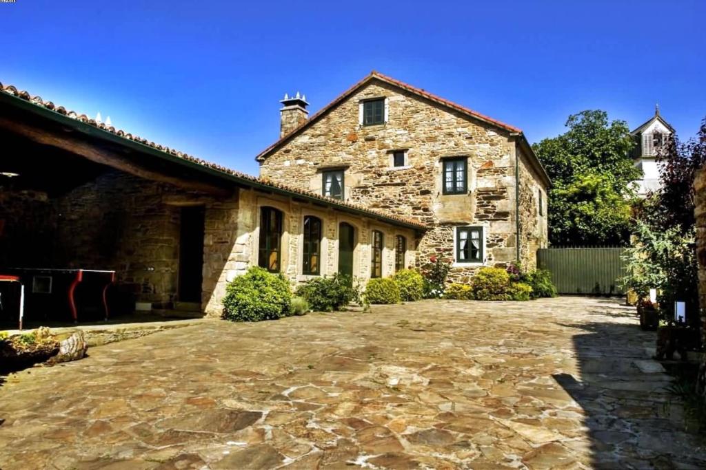 une ancienne maison en pierre avec une allée en pierre dans l'établissement Casa Refugio de Verdes, à Verdes