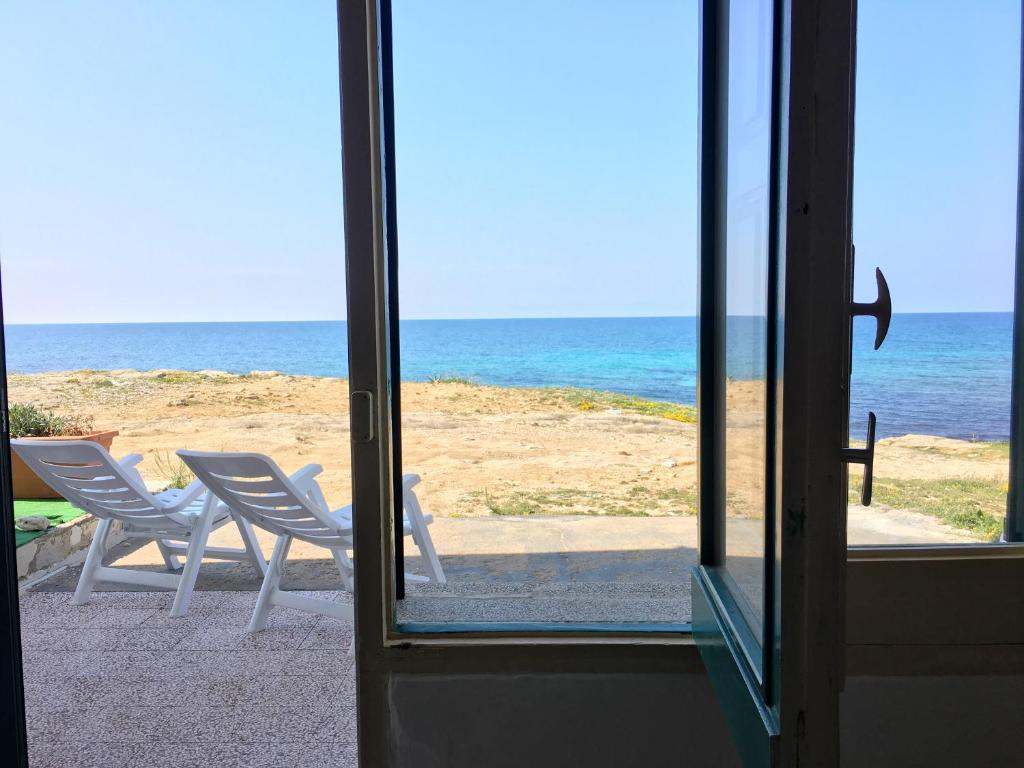 a view of the beach from a window at Appartamento Patrizia in Marina di Mancaversa