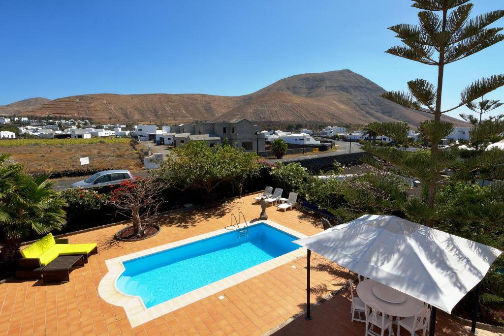 a swimming pool with a view of a resort at Villa Paradise Private Pool Yaiza By PVL in Yaiza