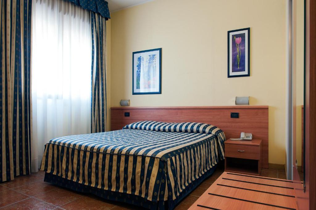Postel nebo postele na pokoji v ubytování Hotel Blue Ribbon