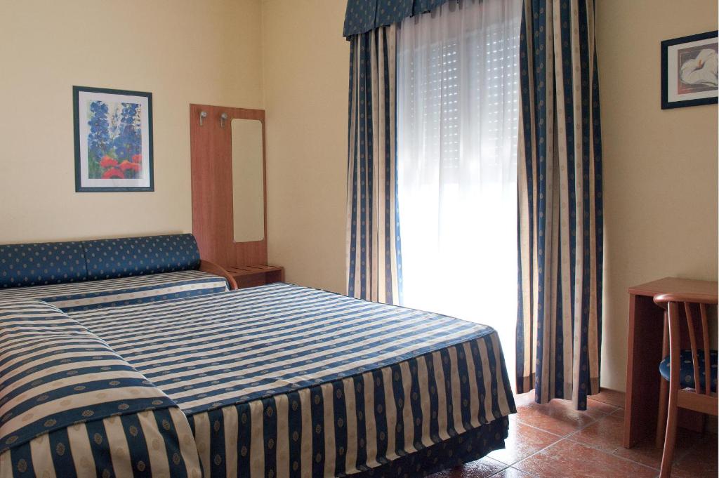 Postel nebo postele na pokoji v ubytování Hotel Blue Ribbon