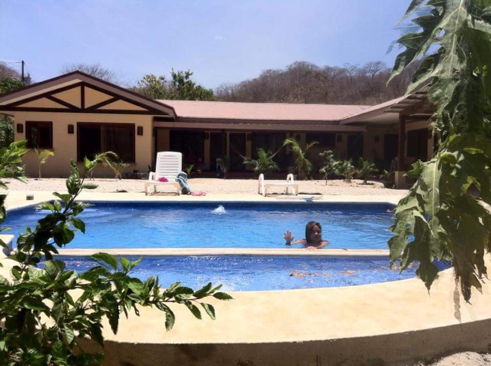 a woman in a swimming pool in a house at Casa Karen in Tamarindo