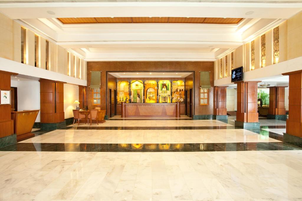 a lobby of a hotel building with a lobby at Welcomhotel by ITC Hotels, Alkapuri, Vadodara in Vadodara
