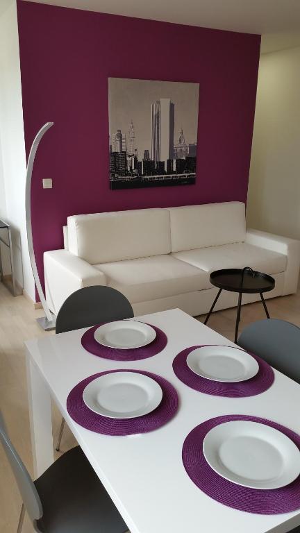 a living room with a table with plates on it at Greg's Great Location Apartment in Ljubljana
