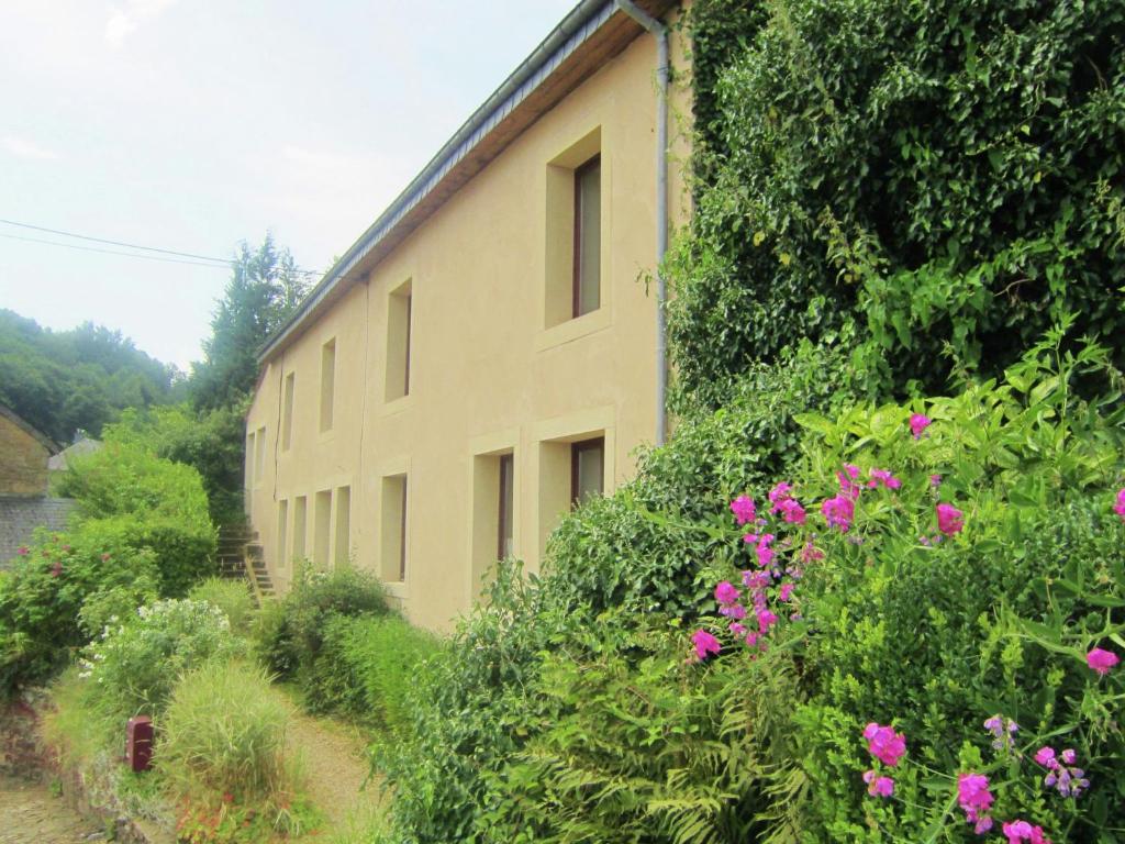 a building with a bunch of flowers in front of it at Modern Farmhouse in Chassepierre with Terrace in Chassepierre