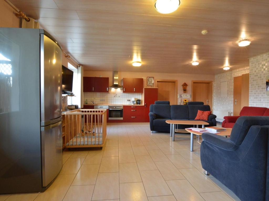 cocina y sala de estar con nevera de acero inoxidable en Spacious Apartment in Gr fflingen with Sauna, en Burg-Reuland