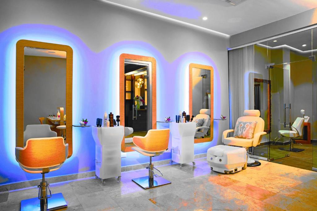 a salon with a lot of chairs and mirrors at Dreams Dominicus La Romana Resort & Spa in Bayahibe