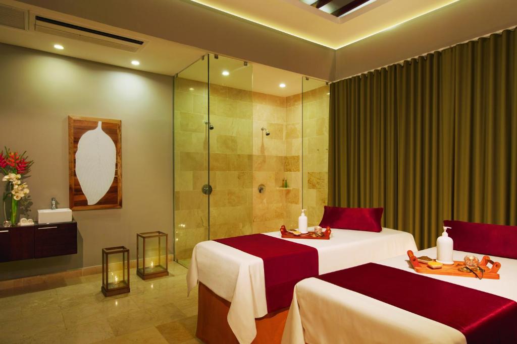 a hotel room with two beds and a shower at Dreams Dominicus La Romana Resort & Spa in Bayahibe