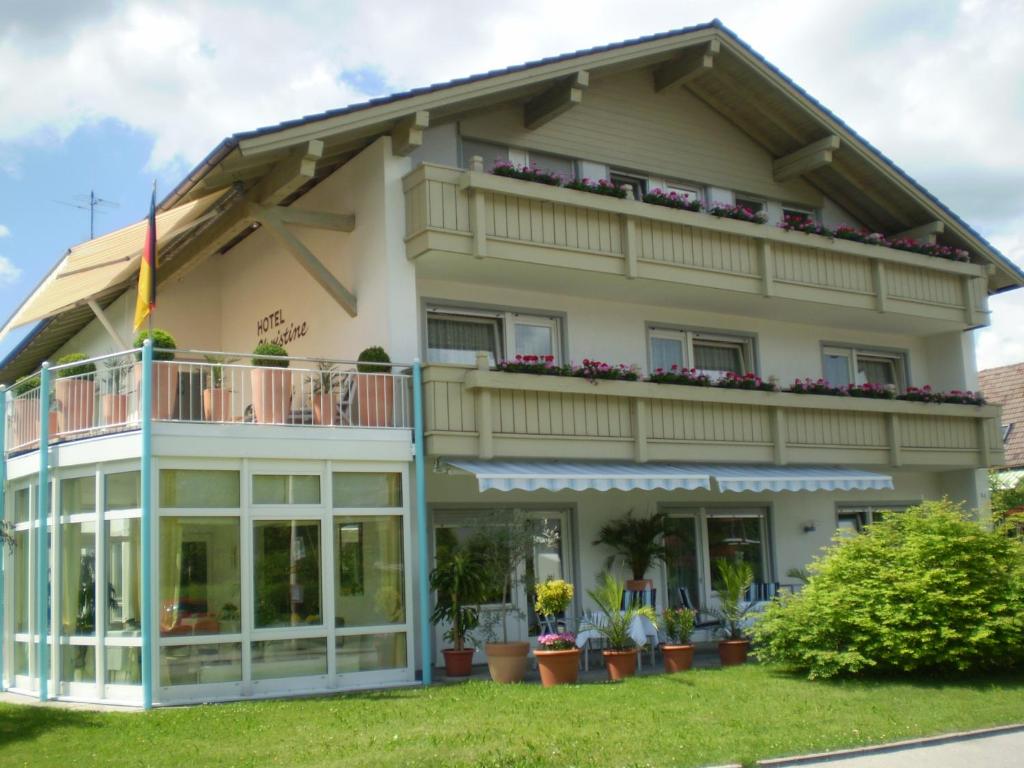 a large house with windows and a balcony at Hotel Christine in Füssen