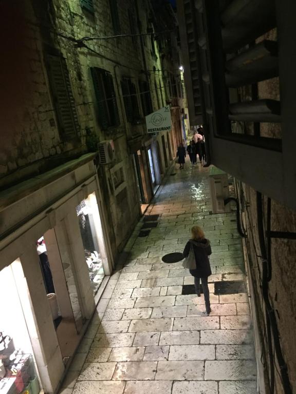 a little girl walking down a street in an alley at Apartments Antonio Premi in Split