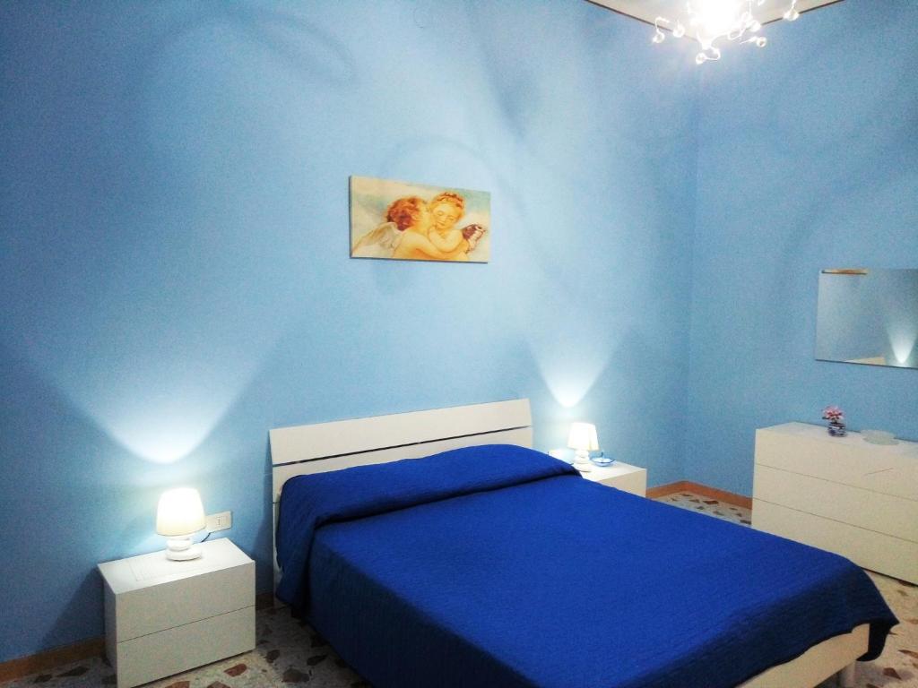 ガリポリにあるCasa Vacanze Serafinaの青いベッドルーム(ベッド1台、ナイトスタンド2台付)