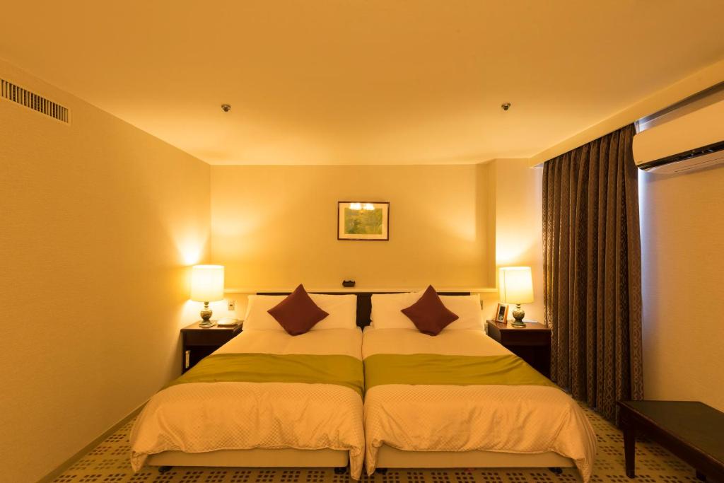 Postel nebo postele na pokoji v ubytování Sky Hotel Uozu