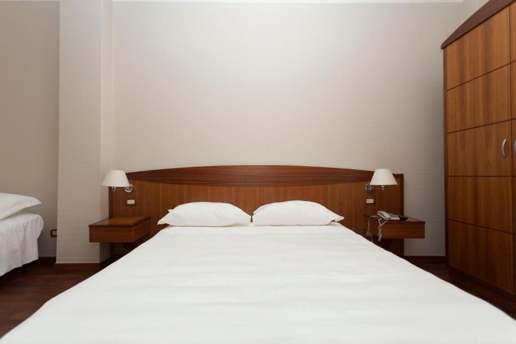 Postel nebo postele na pokoji v ubytování Hotel Cavaliere