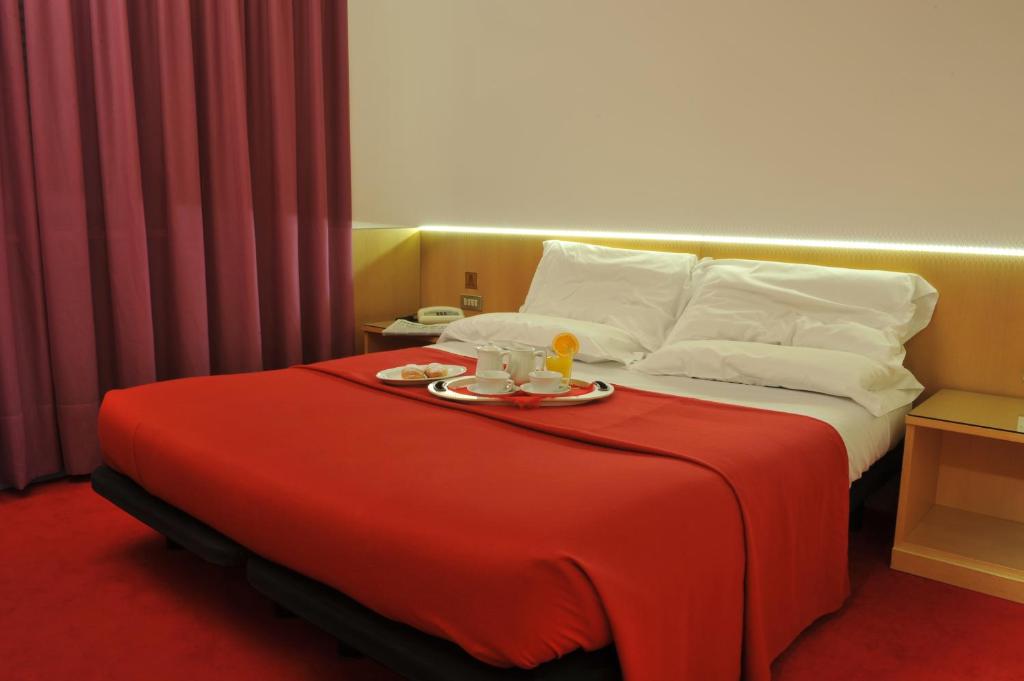 Postel nebo postele na pokoji v ubytování Hotel Ariane