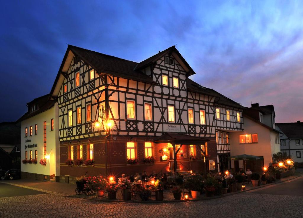 a large building with lights in front of it at Landhotel Zur Grünen Kutte in Bernshausen