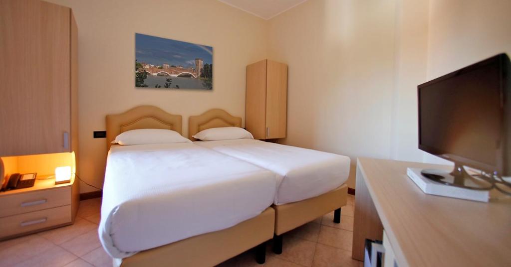 Postel nebo postele na pokoji v ubytování Veronello Resort