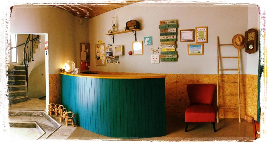 a bar in a room with a chair and a counter at Al-Gharb Tavira Eco GuestHouse in Tavira