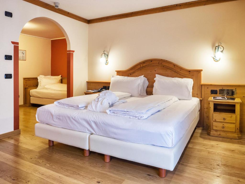 Postel nebo postele na pokoji v ubytování Hotel Bertelli