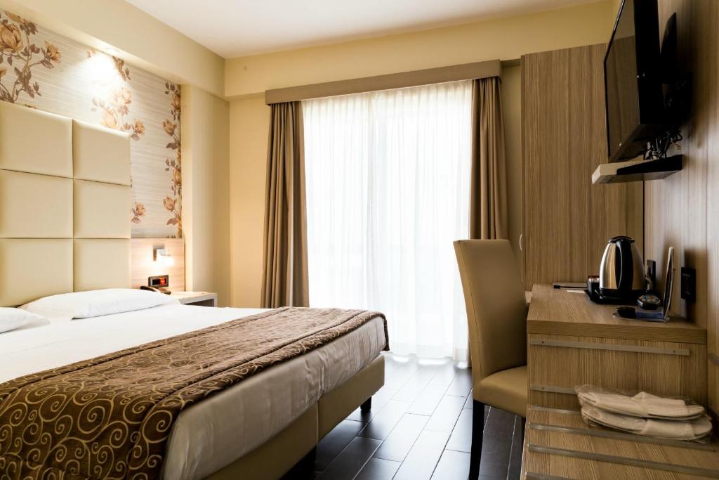Postel nebo postele na pokoji v ubytování Hotel Pineta Palace