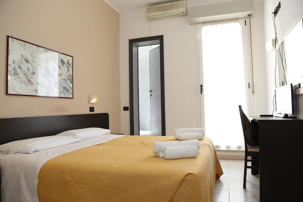 Postel nebo postele na pokoji v ubytování Hotel Villa Dina
