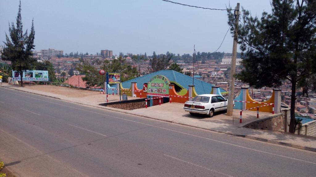 a car parked next to a playground on a city street at Colours Club and Spa in Kigali